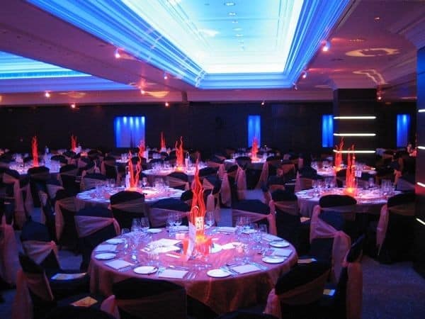 Elegant event setup with floral centerpieces and string lights, ideal for event planning Jacksonville FL.