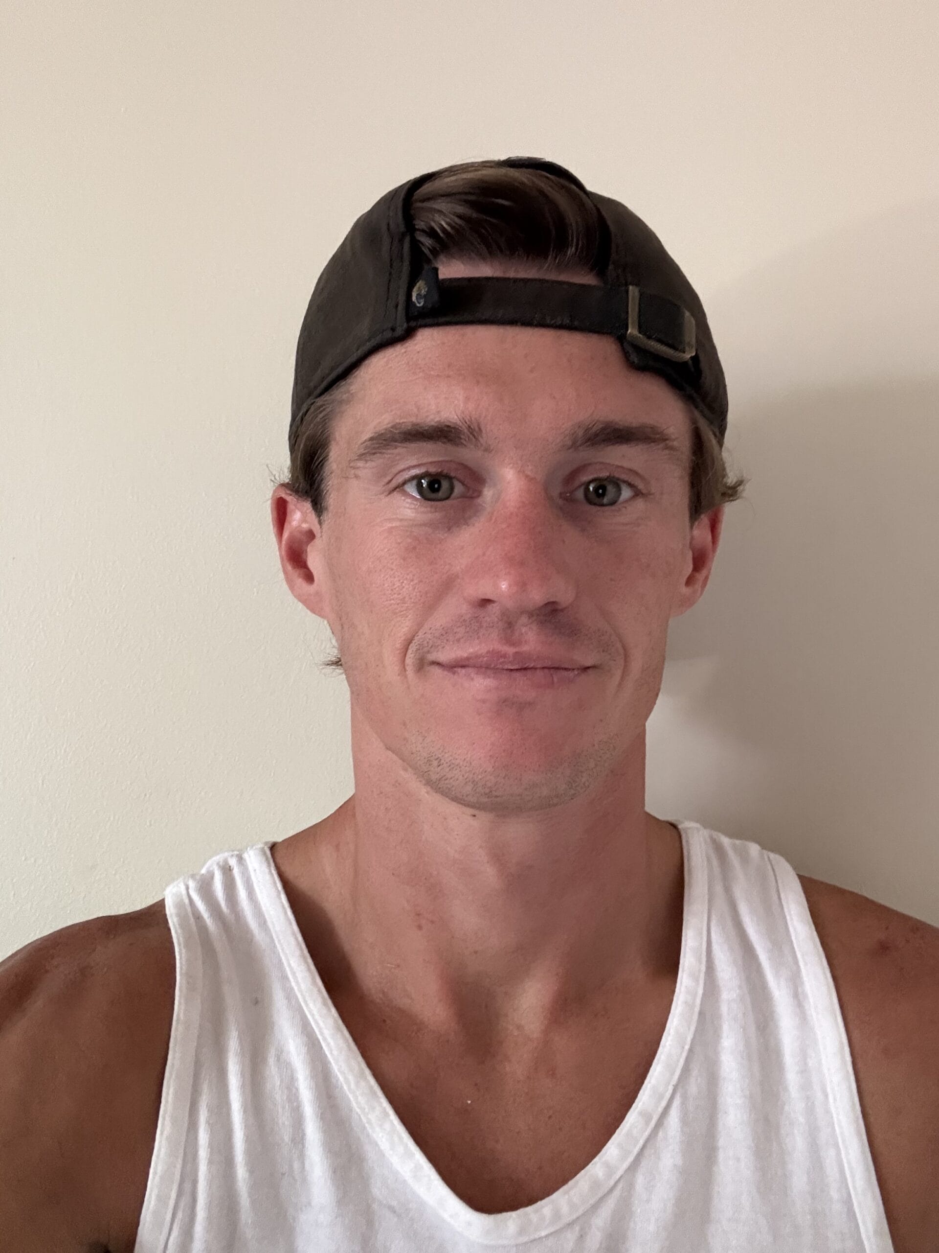 Bryce Wheeler smiling at a Jacksonville party company event planning session, wearing a blue shirt and glasses in an office.