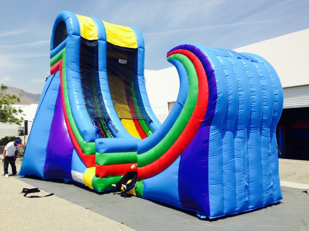 Large inflatable half-pipe ramp for events, featuring vibrant colors and sturdy construction, ideal for parties and gathering