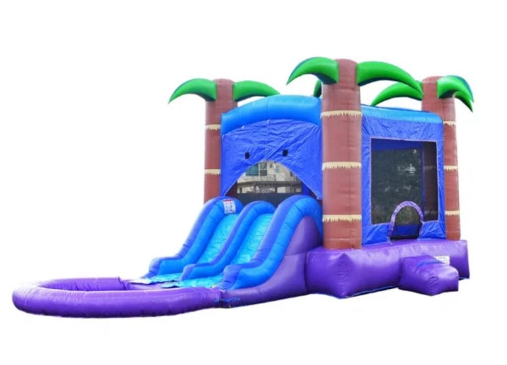 Colorful inflatable tropical-themed toddler play area with slides and palm tree decorations, designed for party rentals.